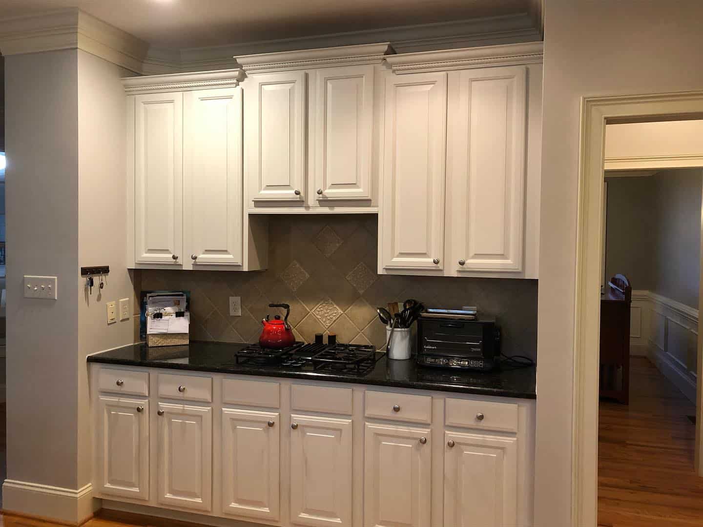 A team of professionals meticulously painting cabinets in Cary, NC.