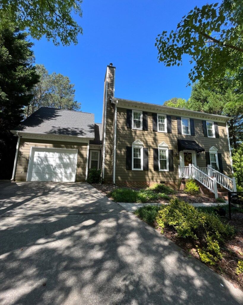 A team of professionals skillfully painting the exterior of a house in Cary, NC.