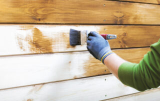 exterior wood siding being primed