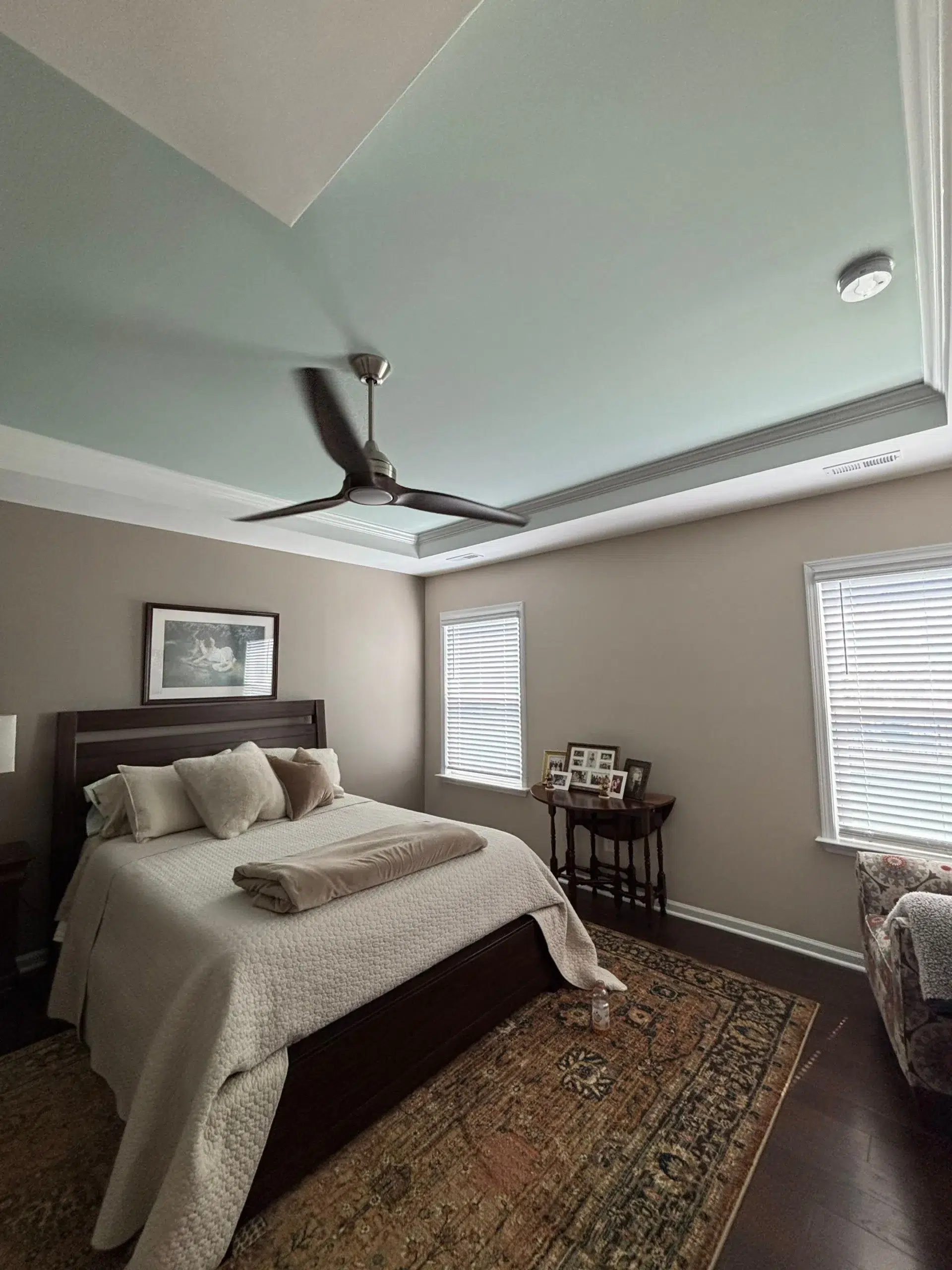 Beautiful Bedroom Interior Painting with Accent Tray Ceiling A cozy bedroom interior with beige walls and a light blue painted accent tray ceiling.